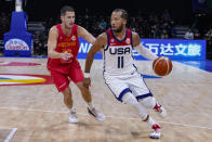 U.S. guard Jalen Brunson (11) drives on Montenegro guard Nikola Ivanovic (20) during the second half of a Basketball World Cup second round match in Manila, Philippines Friday, Sept. 1, 2023. (AP Photo/Michael Conroy)
