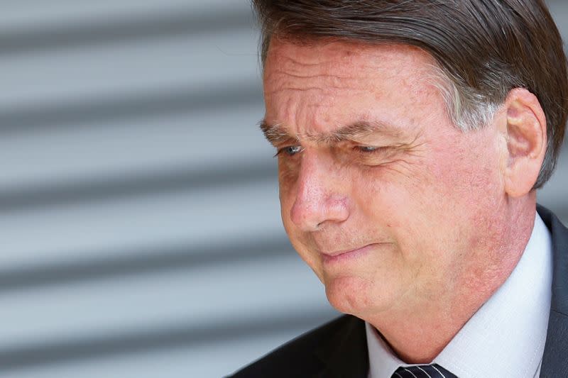 FILE PHOTO: Brazil's President Jair Bolsonaro looks on during a ceremony at the Sao Sebastiao neighbourhood in Brasilia, Brazil