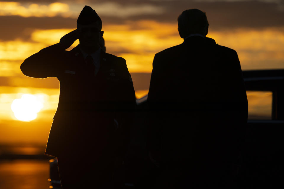 An Airman salutes President Donald Trump as he arrives at Charlotte Douglas International Airport for a campaign rally, Monday, March 2, 2020, in Charlotte, N.C. (AP Photo/Evan Vucci)