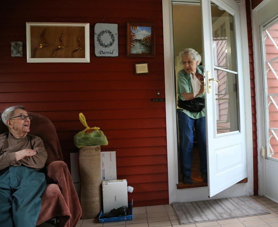 Tonie Darvid glances at his wife Elisabeth as she offers coffee on the porch at their Portsmouth home July 8, 2021.