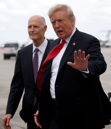 FILE PHOTO: U.S. President Donald Trump is greeted by Florida Governor and Republican U.S. Senate candidate Rick Scott as he arrives in Orlando, Florida, U.S., October 8, 2018. REUTERS/Leah Millis/File Photo