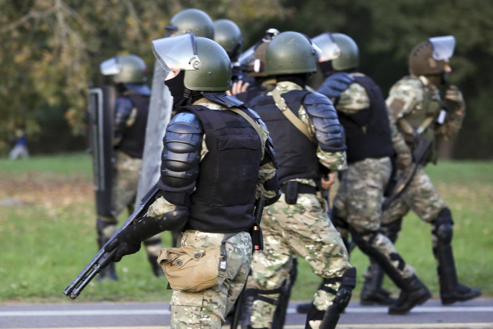 Riot police get ready during an opposition rally to protest the presidential inauguration in Minsk, Belarus, Wednesday, Sept. 23, 2020. Belarus President Alexander Lukashenko has been sworn in to his sixth term in office at an inaugural ceremony that was not announced in advance amid weeks of huge protests saying the authoritarian leader's reelection was rigged. Hundreds took to the streets in several cities in the evening to protest the inauguration. (AP Photo/TUT.by)