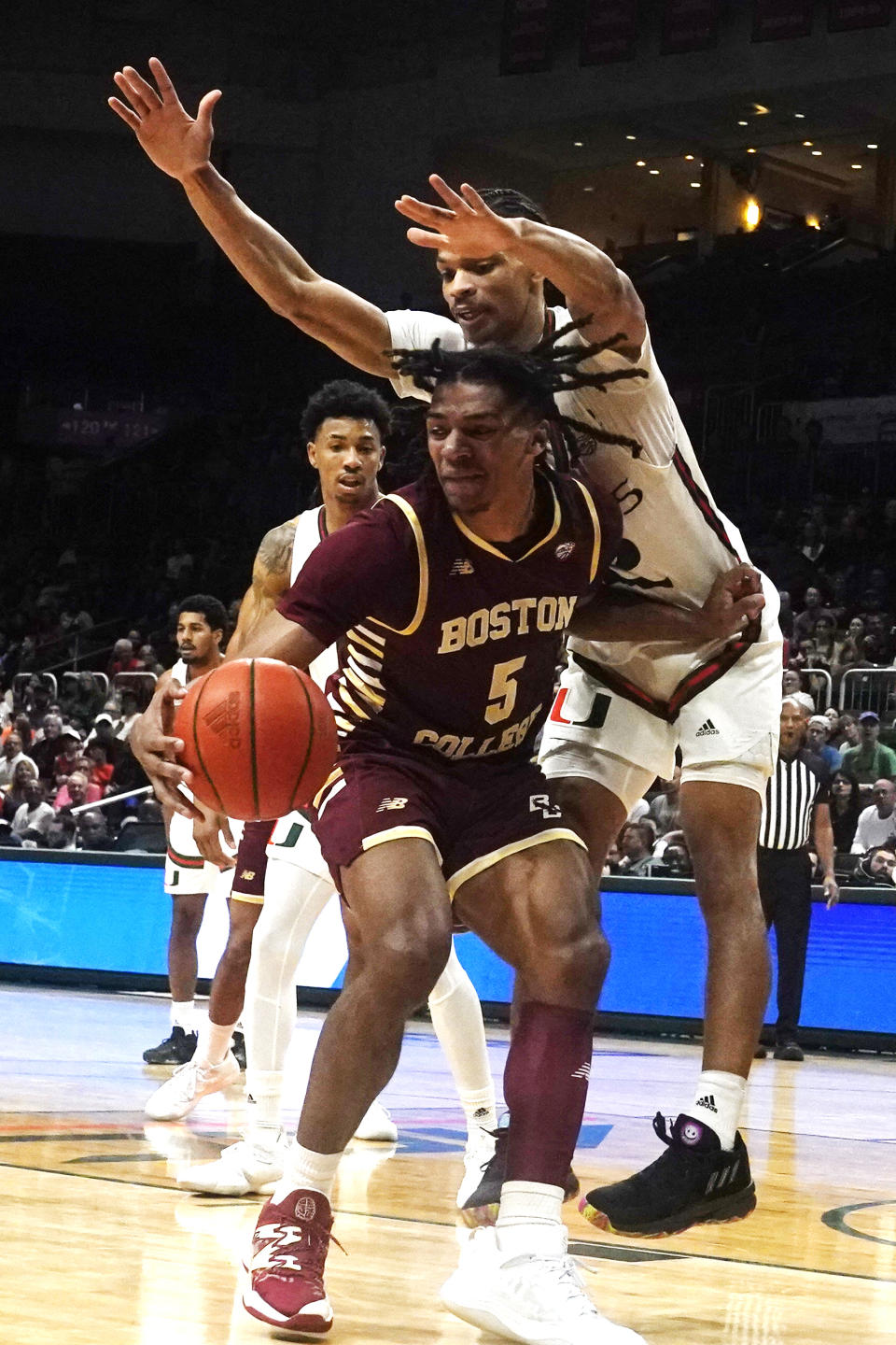 Miami guard Isaiah Wong (2) defends Boston College guard DeMarr Langford Jr. (5) during the second half of an NCAA college basketball game, Wednesday, Jan. 11, 2023, in Coral Gables, Fla. (AP Photo/Marta Lavandier)