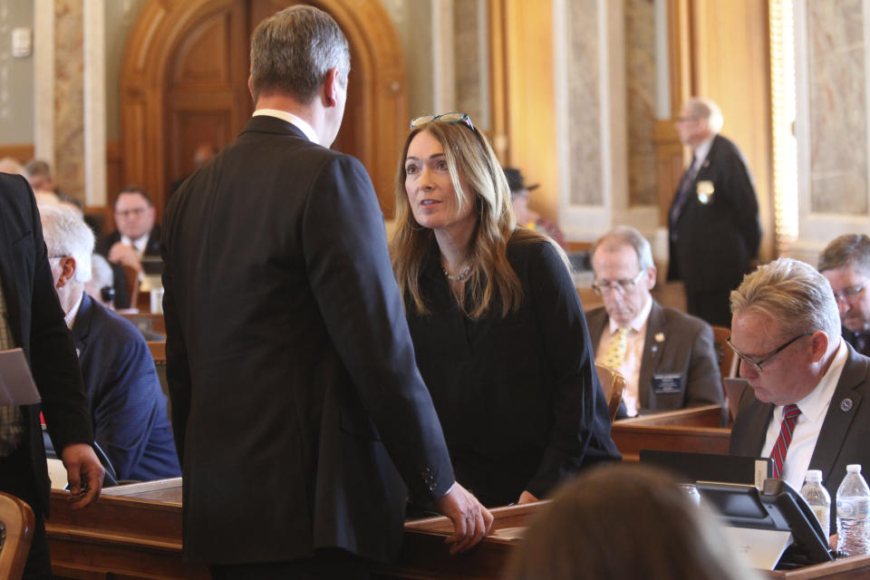 Kansas House K-12 Education Budget Committee Chair Kristey Williams, right, R-Augusta, confers with House Majority Leader Chris Croft, left, R-Overland Park, during a break in a daylong session at the Statehouse in Topeka, Kan., Thursday, April 4, 2024. Williams' committee added a provision to a $6 billion school funding bill that directs up to $5 million in funds for grants to school districts to install technology and use monitoring by a company, ZeroEyes, to identify firearms and quickly notify law enforcement. (AP Photo/John Hanna)