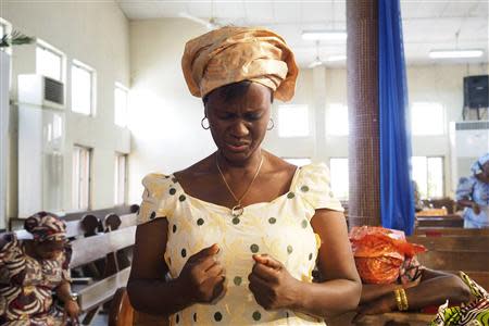 A woman prays for the release of secondary school girls abducted from in the remote village of Chibok, at an Evangelical Church of West Africa (ECWA) church in Abuja May 11, 2014. REUTERS/Joe Penney