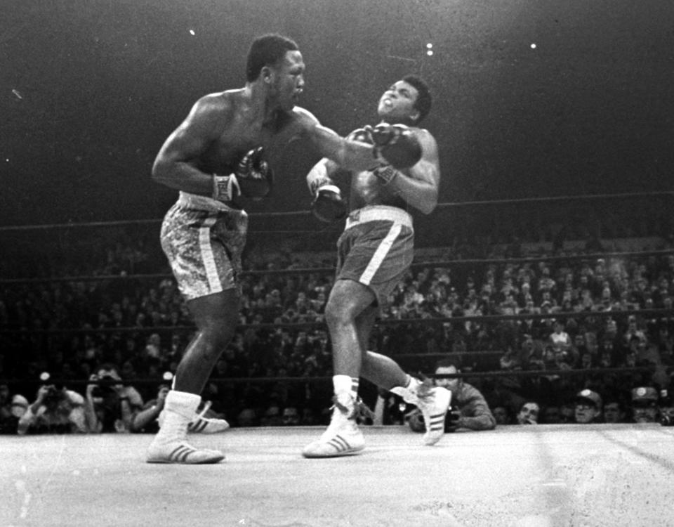 FILE - In this March 8, 1971, file photo, boxer Joe Frazier, left, hits Muhammad Ali during the 15th round of their heavyweight title fight at New York's Madison Square Garden. (AP Photo/File)