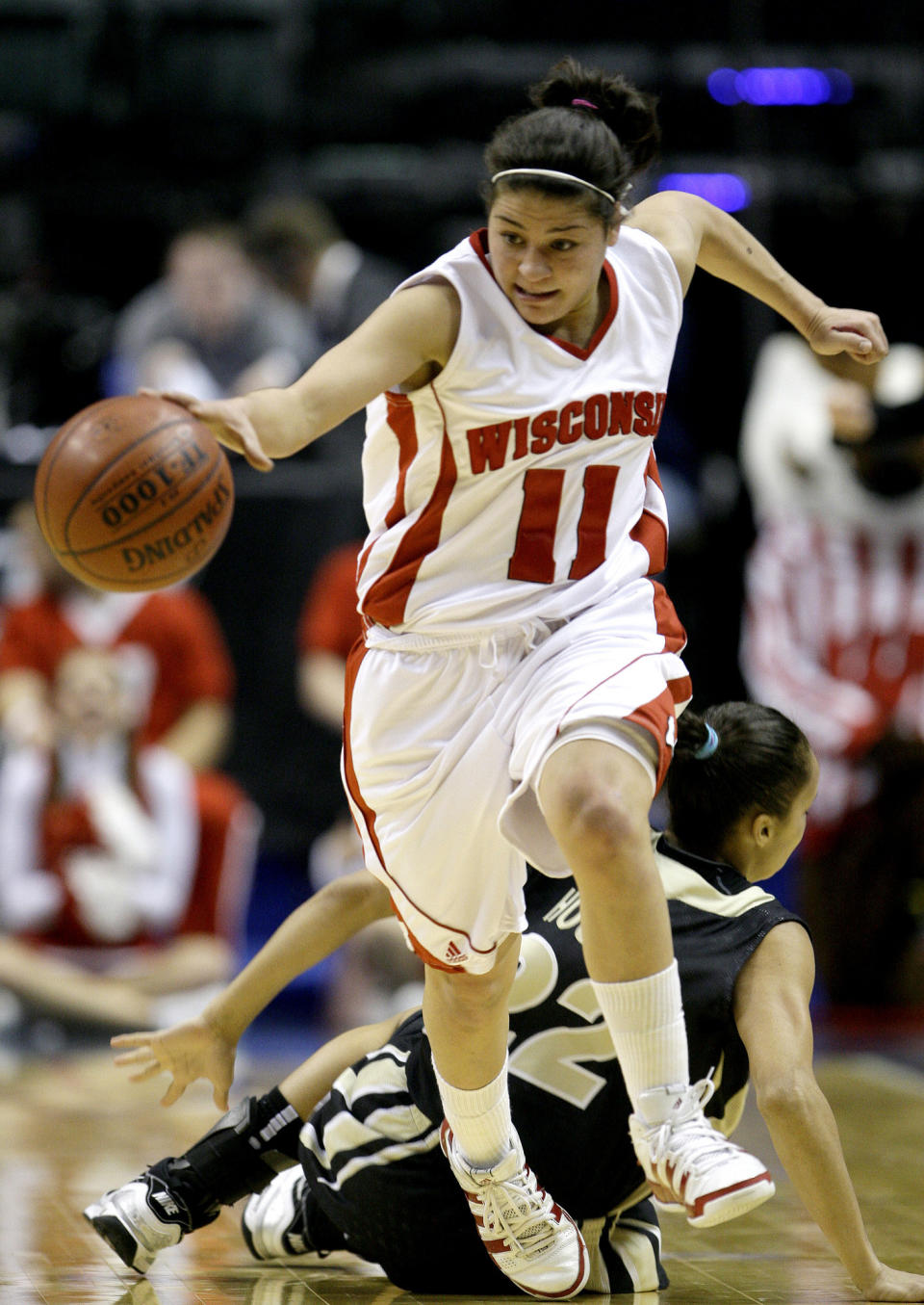 FILE - In this Friday, March 5, 2010 file photo, Wisconsin guard Rae Lin D'Alie, front, make steals the basketball from Purdue guard KK Houser during the first half of an NCAA college basketball game in the second round of the Women's Big Ten NCAA conference tournament in Indianapolis. Rae Lin D'Alie was born and raised in Wisconsin but is the star of Italy's 3-on-3 basketball team at the Tokyo Olympics. “Rae Rae” as she is known usually is the shortest player on the court at 5-foot-3 but is Italy's spark plug and court general. (AP Photo/Darron Cummings, File)