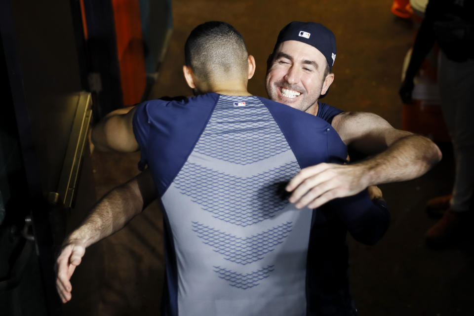 Houston Astros' Carlos Correa celebrates after his walk-off home run with starting pitcher Justin Verlander against the New York Yankees during the 11th inning in Game 2 of baseball's American League Championship Series Monday, Oct. 14, 2019, in Houston. (AP Photo/Matt Slocum)