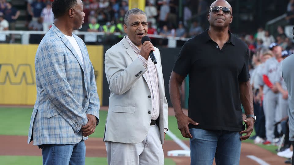 Willie Mays' son, Michael Mays, addresses the crowd aside baseball greats Ken Griffey Jr., left, and Barry Bonds, right. - Vasha Hunt/AP