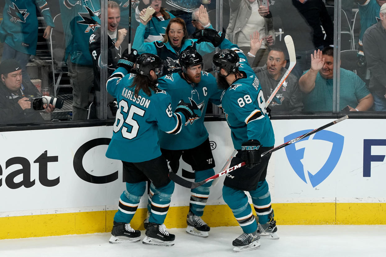 SAN JOSE, CALIFORNIA - MAY 11: Joe Pavelski #8 of the San Jose Sharks celebrates with his teammates Erik Karlsson #65 and Brent Burns #88 after scoring a goal on Jordan Binnington #50 of the St. Louis Blues during the first period in Game One of the Western Conference Finals during the 2019 NHL Stanley Cup Playoffs at SAP Center on May 11, 2019 in San Jose, California. (Photo by Thearon W. Henderson/Getty Images)