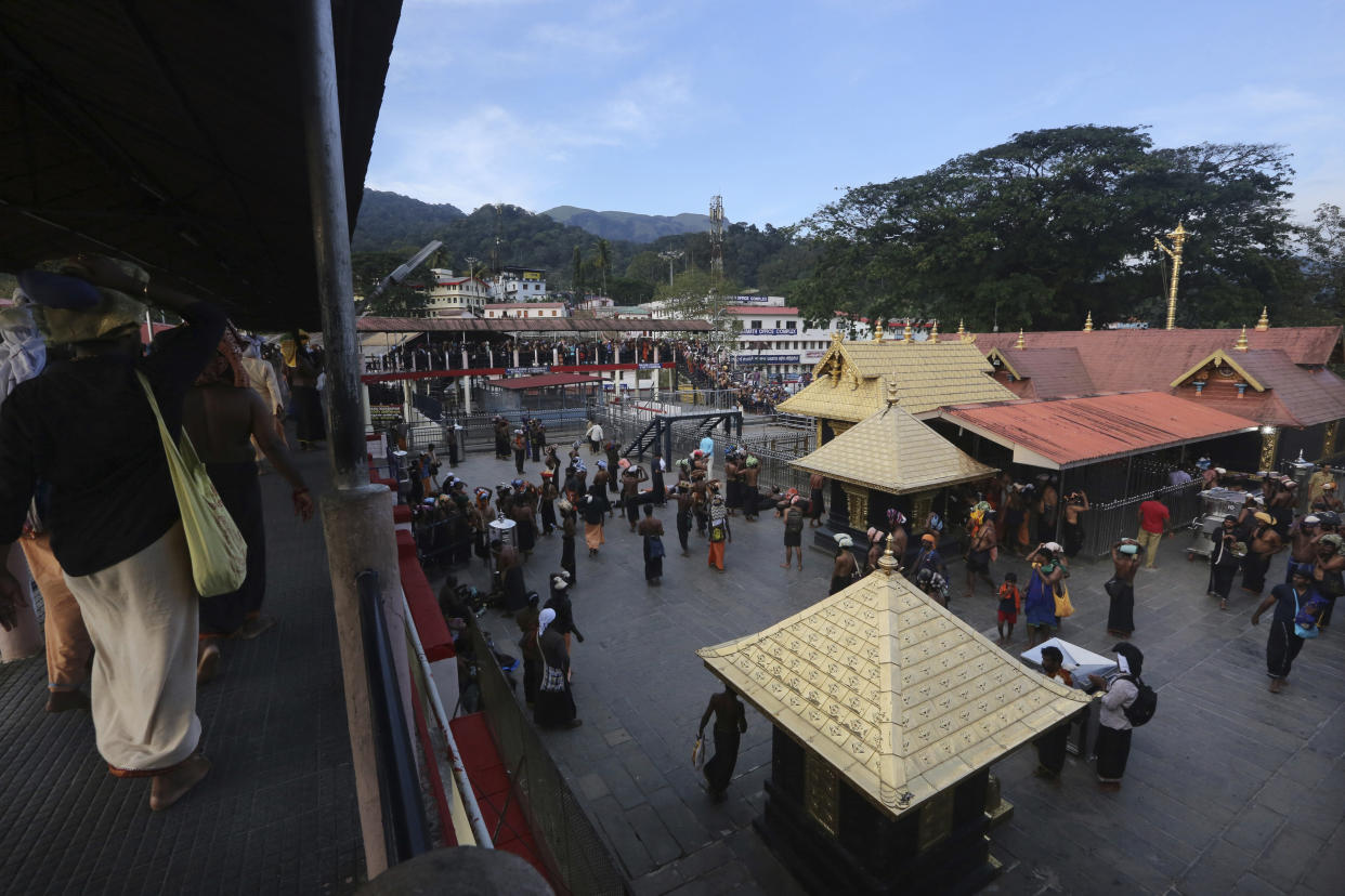 Devotees carrying customary offerings on their heads arrive to worship at the Sabarimala temple, one of the world's largest Hindu pilgrimage sites in Kerala state, India, on Nov. 5. The historic temple, which had barred women age 10 to 50 from entering, opened to Hindu pilgrims for a day. The last time it was opened, conservative protesters blocked women of menstruating age from going to the temple, defying a recent ruling from India's top court to let them enter.&nbsp; (Photo: Associated Press)