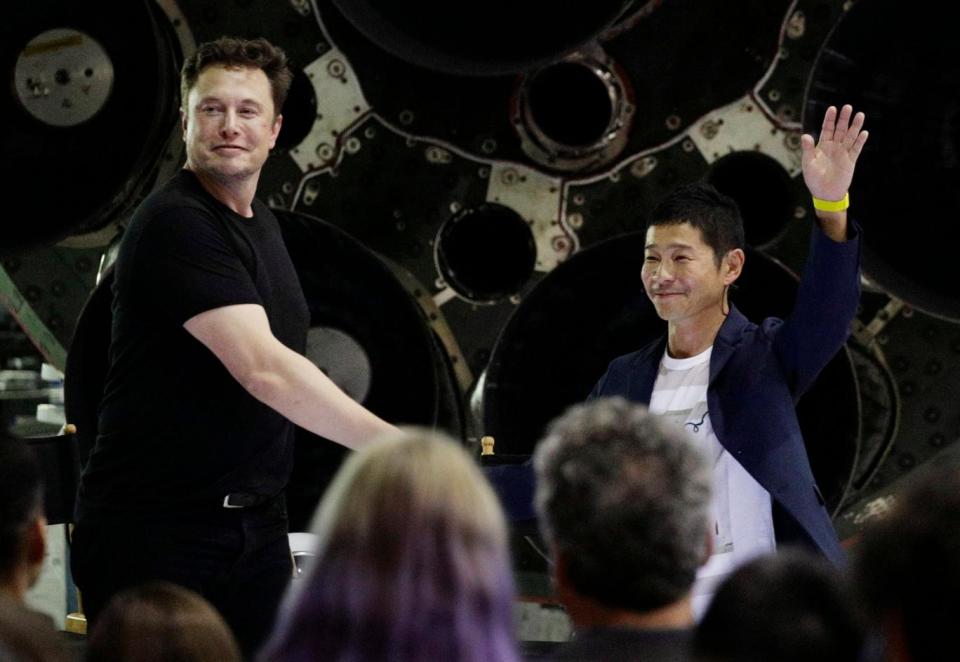 SpaceX founder and chief executive Elon Musk, left, shakes hands with Japanese billionaire Yusaku Maezawa, right, after announcing him as the first private passenger on a trip around the moon. (AP)