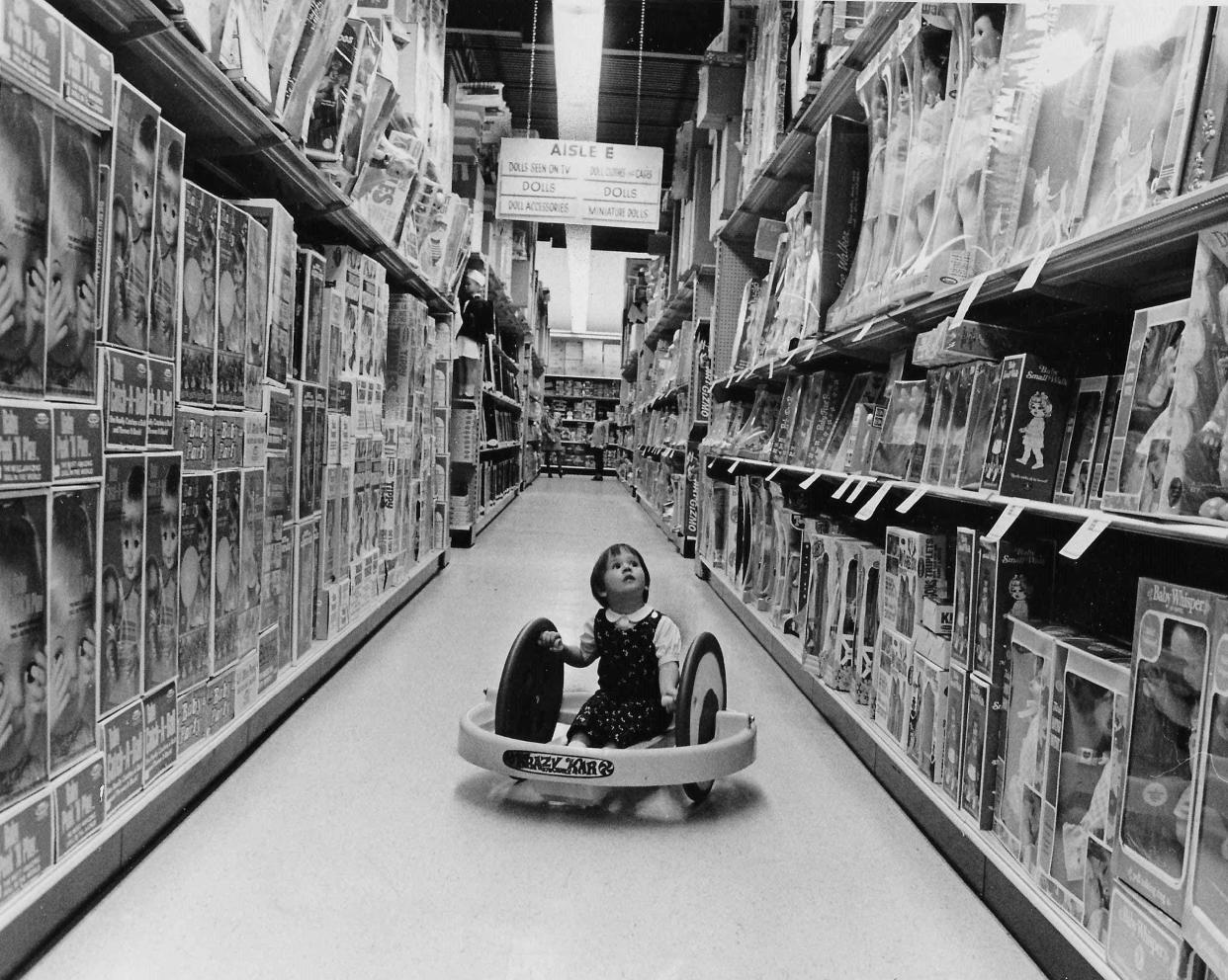 Margot Kuhne, 4, of Akron, sits in a Krazy Kar in 1969 and looks up at the toy shelves inside the brand-new Children's Palace on Akron-Cleveland Road in Northampton Township (now Cuyahoga Falls).