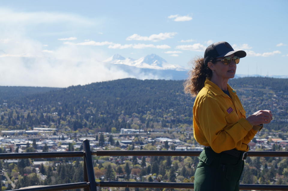 Jodie Barram, co-coordinator for Oregon Living With Fire, stands atop Pilot Butte in Bend to answer questions about a prescribed burn taking place near the city. (Alex Baumhardt/Oregon Capital Chronicle)