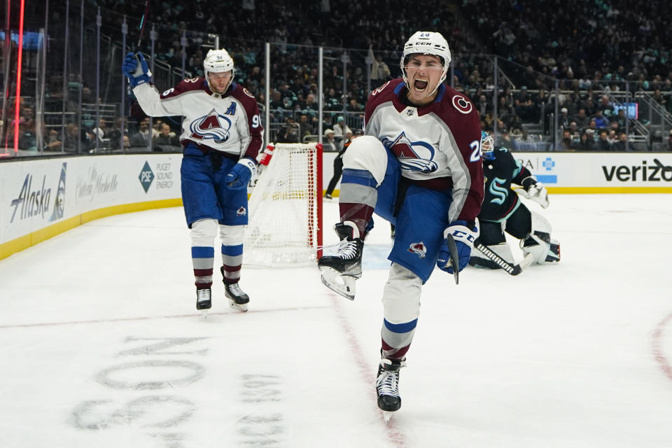 Colorado Avalanche center Ross Colton, right, reacts after scoring against the Seattle Kraken as teammate Mikko Rantanen, left, skates over to join him during the second period of an NHL hockey game Monday, Nov. 13, 2023, in Seattle. (AP Photo/Lindsey Wasson)