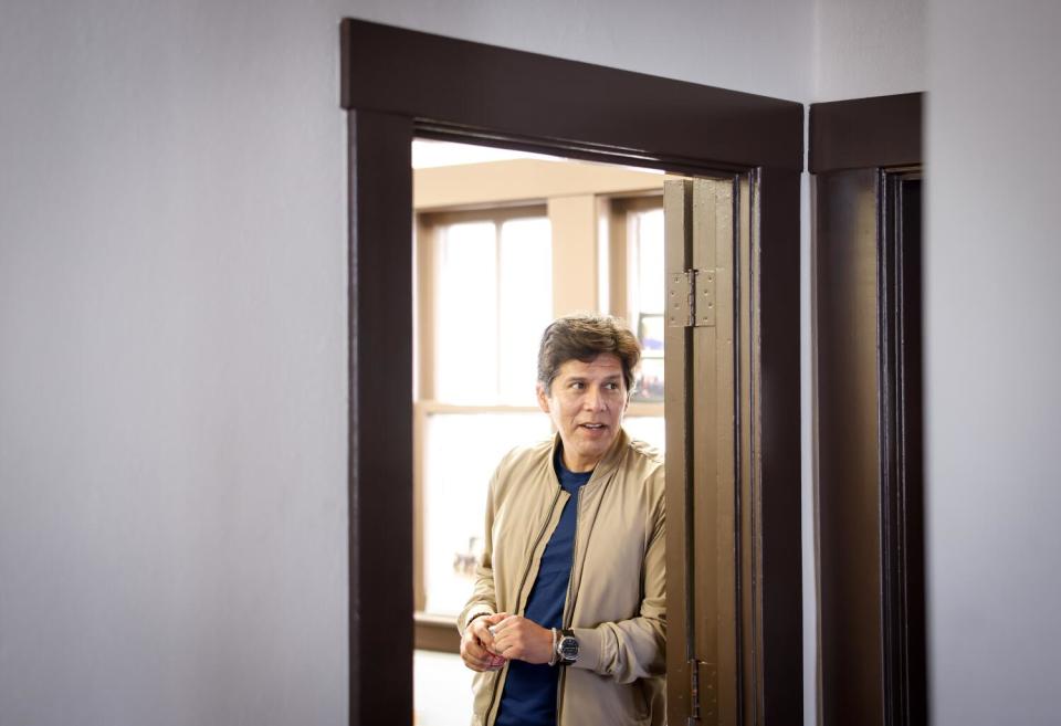 Los Angeles City Councilman Kevin de León leans against a doorframe.