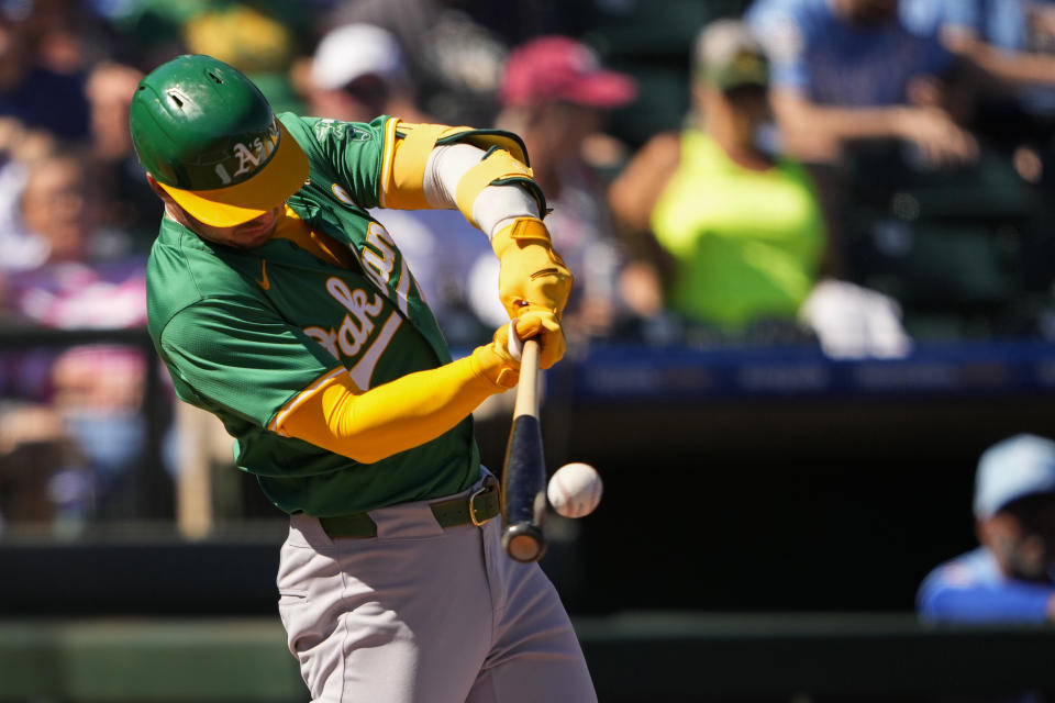 Oakland Athletics' Brent Rooker hits a single against the Kansas City Royals during the first inning of a spring training baseball game Friday, March 1, 2024, in Surprise, Ariz. (AP Photo/Lindsey Wasson)