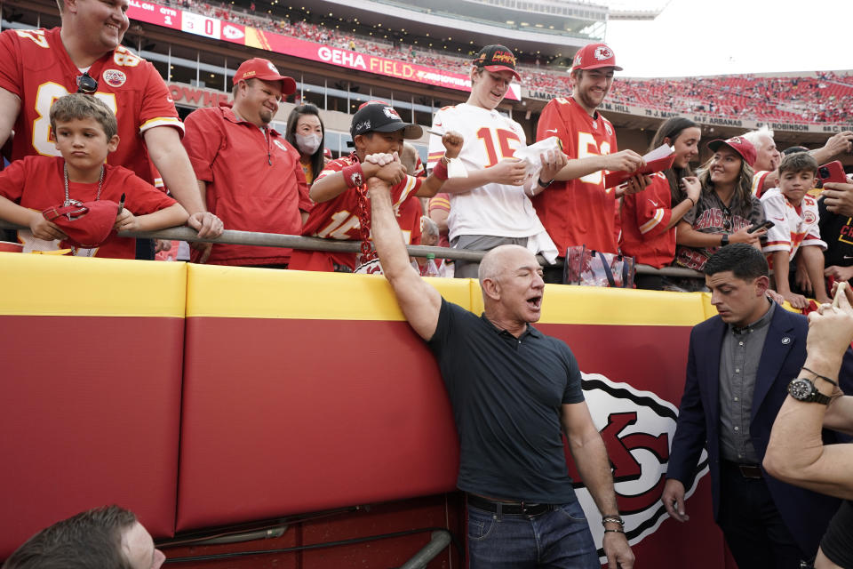 Amazon founder Jeff Bezos greets fans before the start of an NFL football game between the Kansas City Chiefs and the Los Angeles Chargers Thursday, Sept. 15, 2022, in Kansas City, Mo. (AP Photo/Ed Zurga)