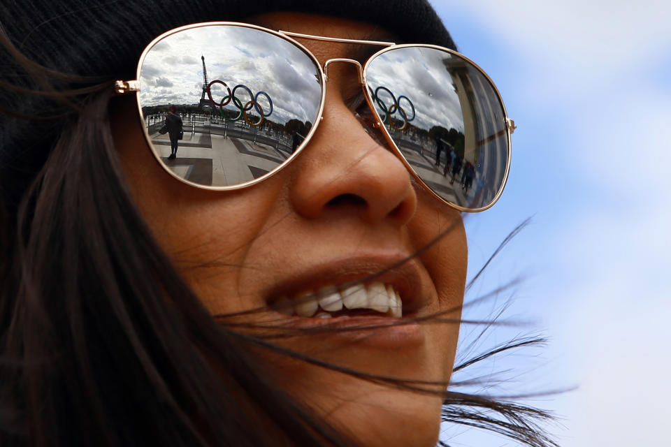 FILE - The Olympic rings are reflected on sunglasses, on Trocadero plaza that overlooks the Eiffel Tower, a day after the official announcement that the 2024 Summer Olympic Games will be in the French capital, in Paris, Sept. 14, 2017. (AP Photo/Francois Mori, File)