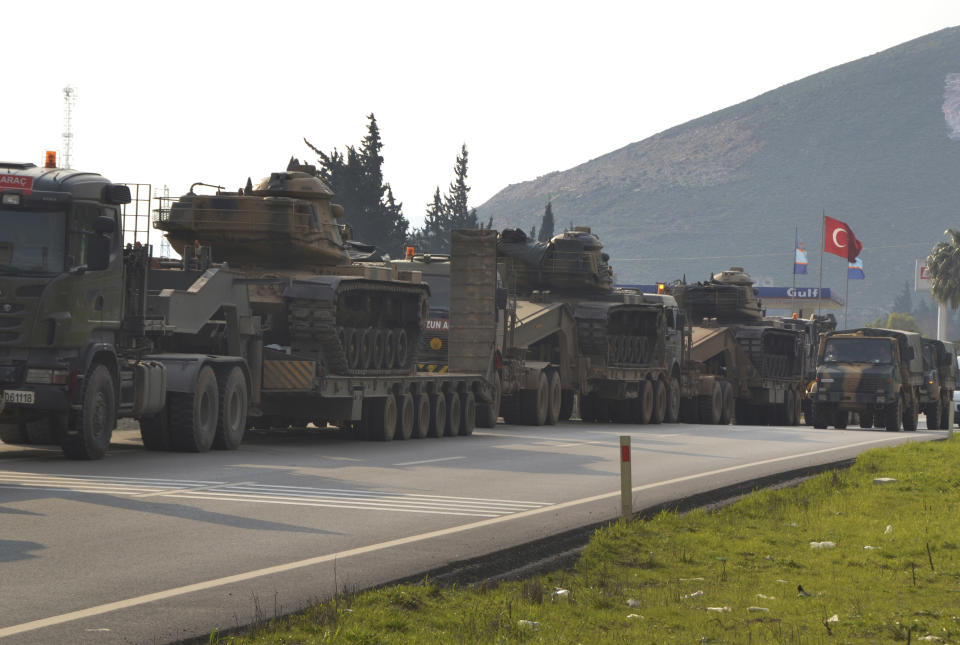 A convoy of Turkish military trucks carrying tanks and armoured personnel carriers destined for Syria in preparation for a possible military offensive, moves in Hatay province, southeastern Turkey, near the border with Syria, Monday, Jan. 14, 2019. U.S. Secretary of State Mike Pompeo said Monday that U.S. President Donald Trump's threat to devastate NATO ally Turkey's economy if it attacks U.S.-backed Kurdish fighters in Syria underscores America's commitment to its partners. (Mehmet Kocacik/Kirikhan/DHA via AP)