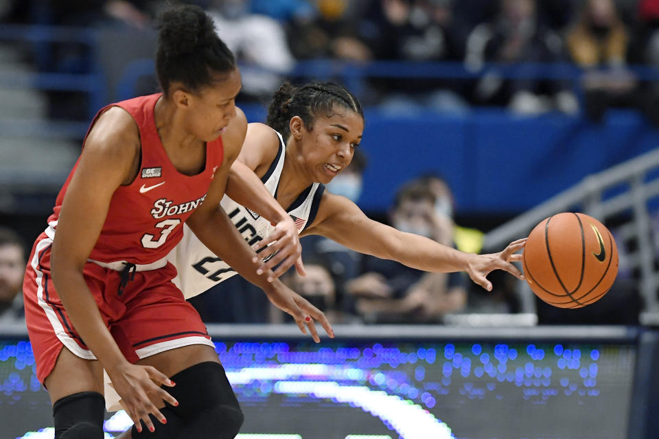 Connecticut's Evina Westbrook, back, intercepts a pass intended for St. John's Danielle Patterson during the second half of an NCAA college basketball game Friday, Feb. 25, 2022, in Hartford, Conn. (AP Photo/Jessica Hill)