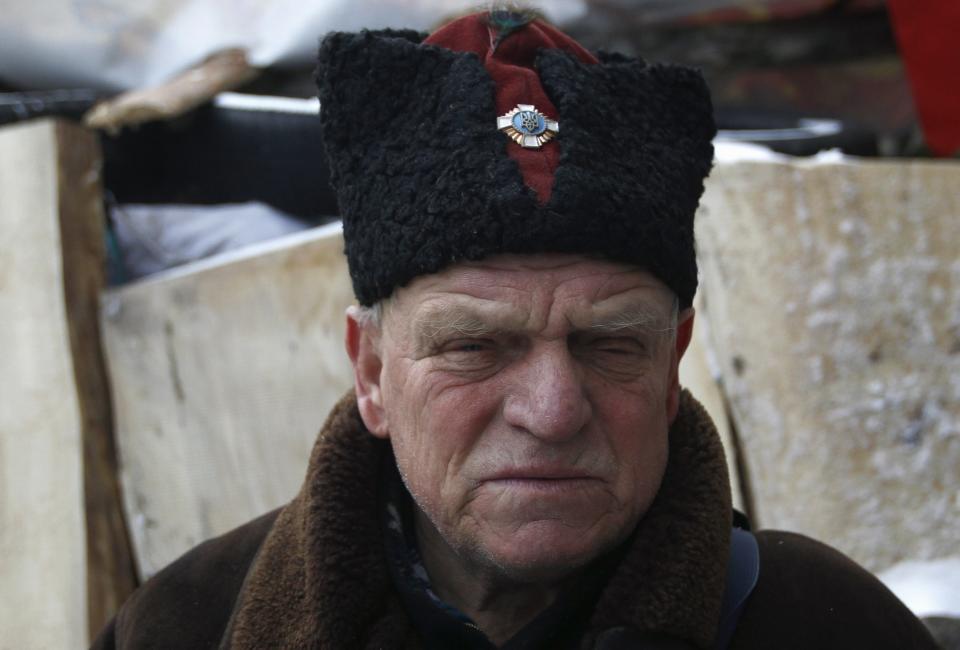 A Cossack poses for a picture in a demonstrators' camp during a rally held by anti-government protesters in Independence Square in central Kiev