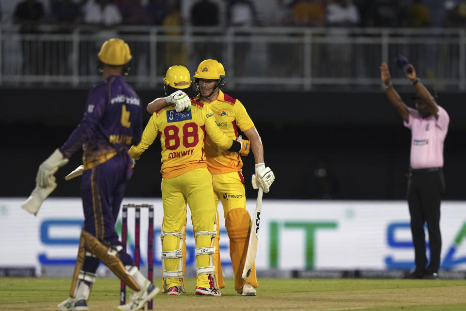 Texas Super Kings' Devon Conway (88) and David Miller hug after scoring during the team's Major League Cricket match against the Los Angeles Knight Riders in Grand Prairie, Texas, Thursday, July 13, 2023. (AP Photo/LM Otero)