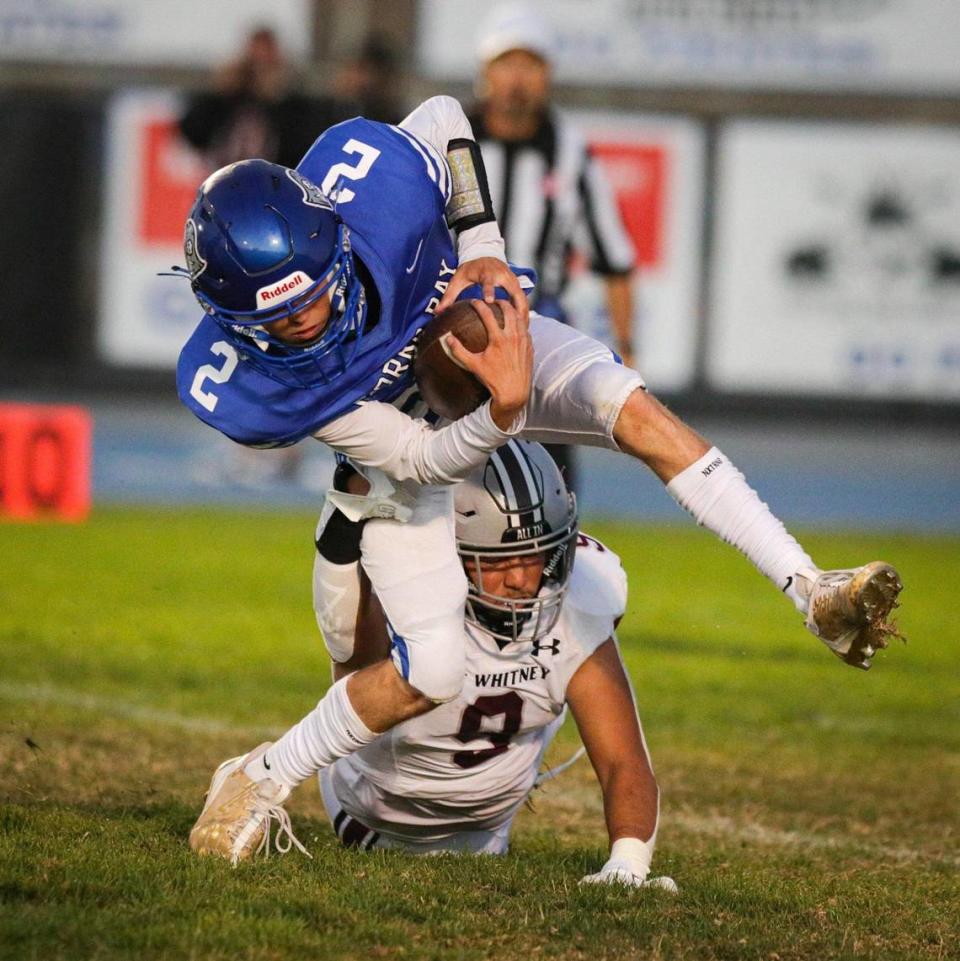 Ian Lambright is tackled by Mario Rodriguez after a high snap. Morro Bay hosted Mt. Whitney High School for week two of the football season. The Pirates fell to the Pioneers 28-16.