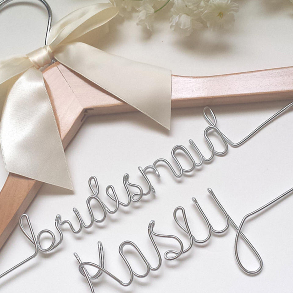 <p>This one is as much a gift to you as much as it is for your girls. Order a custom hanger with their names for their bridesmaid dresses-a cool keepsake that’ll also look great in your wedding photos.</p><p>$18 | <a rel="nofollow noopener" href="https://affordableweddinghangers.com/collections/custom-wedding-hangers/products/custom-two-tier-wedding-hanger-for-the-bridesmaid" target="_blank" data-ylk="slk:SHOP IT;elm:context_link;itc:0;sec:content-canvas" class="link ">SHOP IT</a></p>