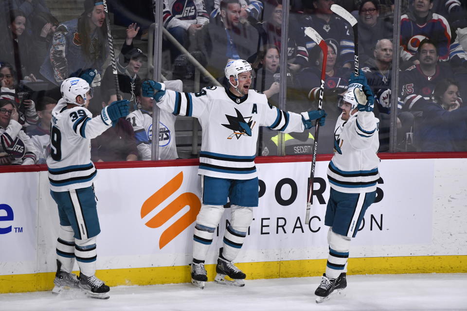San Jose Sharks' Tomas Hertl (48) celebrates after his goal against the Winnipeg Jets with Logan Couture (39) and Andreas Johnsson (18) during third-period NHL hockey game action in Winnipeg, Manitoba, Monday, March 6, 2023. (Fred Greenslade/The Canadian Press via AP)