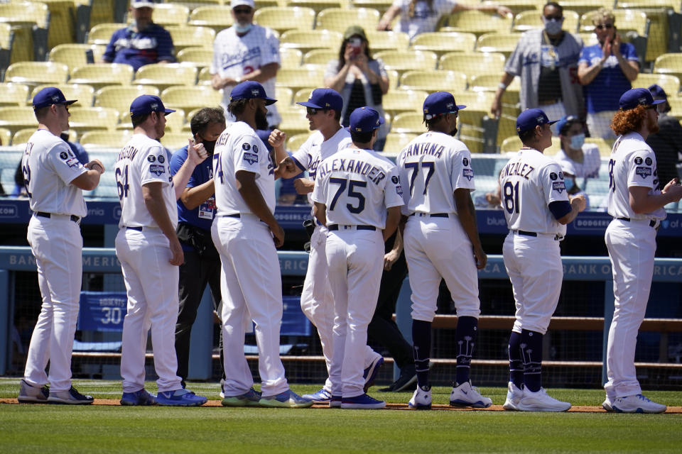 Members of the Los Angeles Dodgers greet each other during player introductions before a baseball game against the Washington Nationals, Friday, April 9, 2021, in Los Angeles. (AP Photo/Marcio Jose Sanchez)