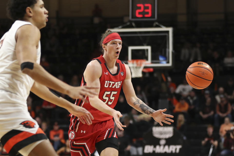 Utah guard Gabe Madsen (55) passes the ball away from Oregon State forward Michael Rataj during the second half of an NCAA college basketball game in Corvallis, Ore., Thursday, Jan. 26, 2023. Utah won 63-44. (AP Photo/Amanda Loman)