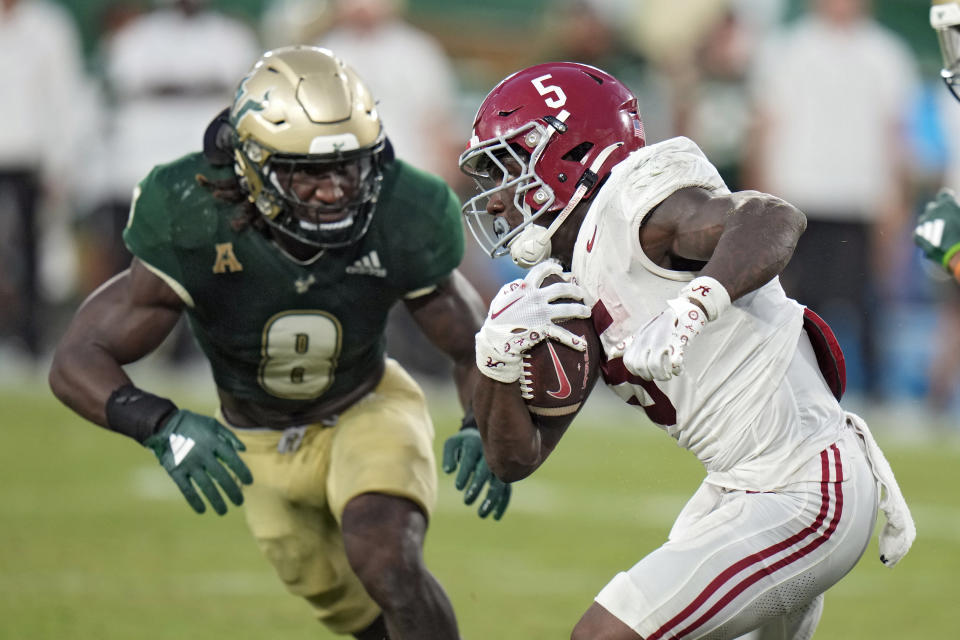 Alabama running back Roydell Williams (5) gets past South Florida linebacker DJ Gordon IV (8) on a run during the second half of an NCAA college football game Saturday, Sept. 16, 2023, in Tampa, Fla. (AP Photo/Chris O'Meara)