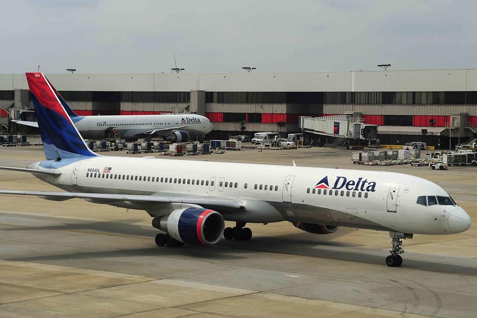 <p>KAREN BLEIER/AFP via Getty </p> A Delta Airlines jets arrives at Atlanta-Hartsfield International Airport in Atlanta, Georgia