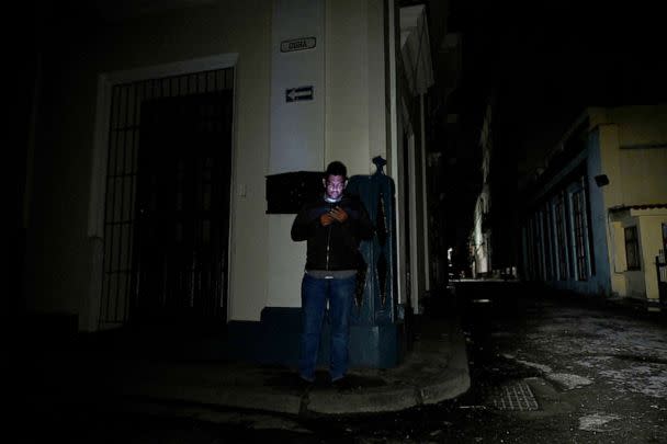 PHOTO: A man uses his cell phone on a street during a blackout in Havana, on Sept. 27, 2022. (Yamil Lage/AFP via Getty Images)
