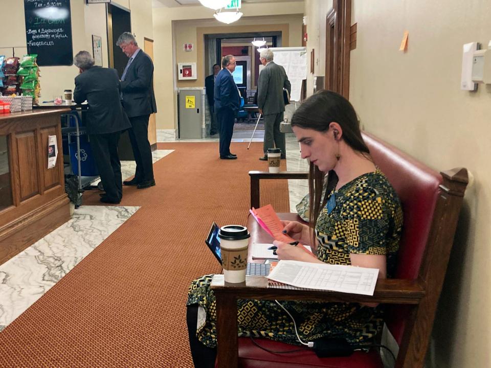 State Rep. Zooey Zephyr sits in a couch in a hallway just outside the main chamber of the House, Thursday, April 27, 2023 in Helena, Montana.