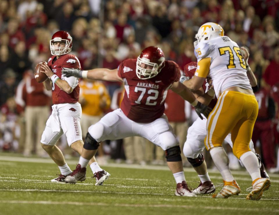Nov 12, 2011; Fayetteville, AR, USA; Arkansas Razorbacks quarterback Tyler Wilson (8) looks to make a pass as offensive guard Grant Cook (72) blocks Tennessee Volunteers defensive linemen Daniel Hood (76) during a game at Donald W. Reynolds Razorback Stadium. Arkansas defeated Tennessee 49-7. Mandatory Credit: Beth Hall-USA TODAY Sports