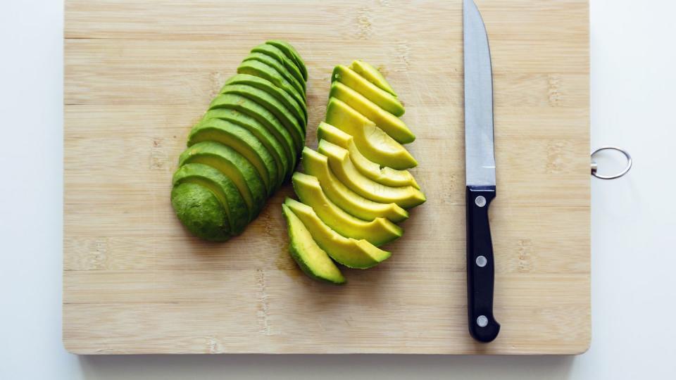 freshly cut sliced avocado on a cutting board