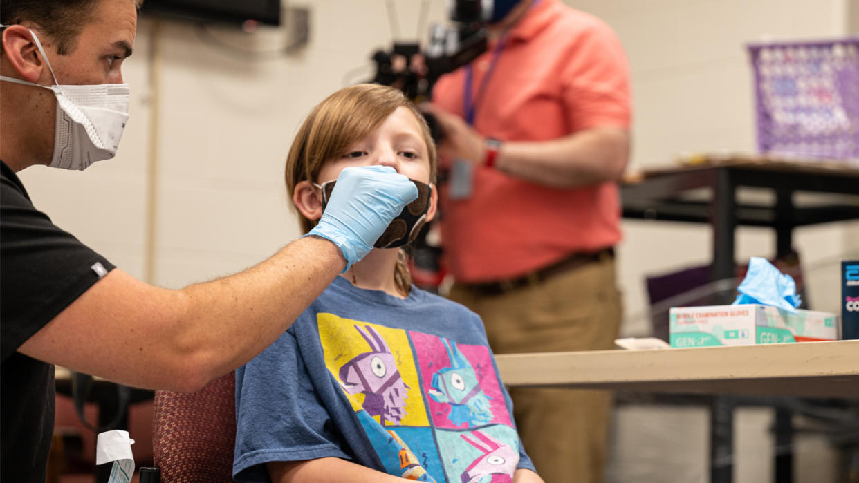 A fourth grader in Louisville, Ky., is given a COVID test.