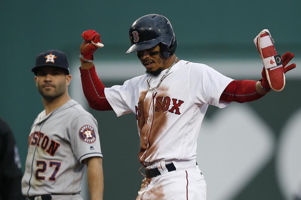 Boston Red Sox's Mookie Betts reacts in front of Houston Astros' Jose Altuve (27) after hitting a double during the third inning of a baseball game in Boston, Saturday, Sept. 8, 2018. (AP Photo/Michael Dwyer)