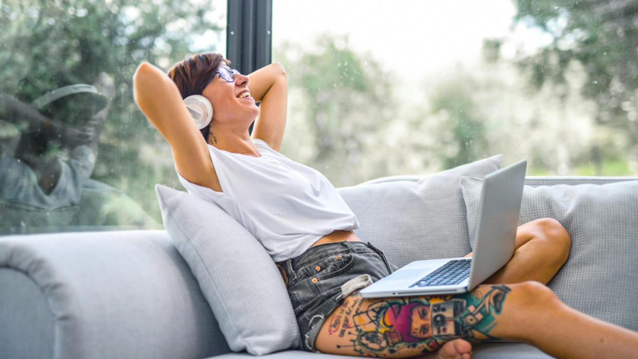  Woman listening to music on laptop. 