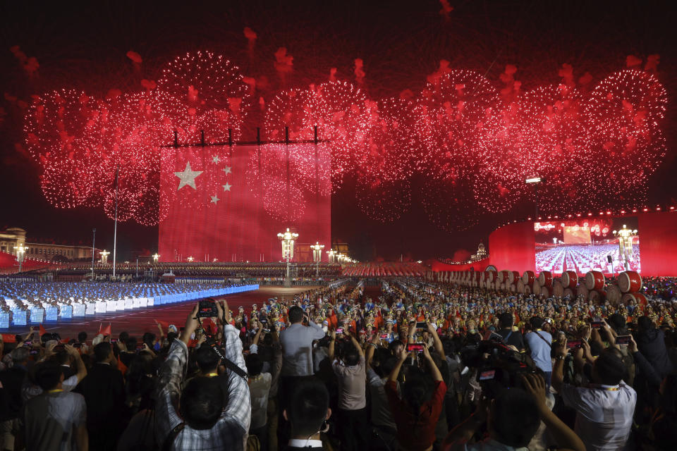 Fireworks and a giant Chinese national flag formed by lights are seen at the evening gala held on Tiananmen Square for the 70th anniversary of the founding of the People's Republic of China in Beijing on Tuesday, Oct. 1, 2019. Tiananmen Square is both where leader Mao Zedong declared the founding of the People's Republic of China in 1949 and where pro-democracy protesters rallied in 1989 before being quashed by the military in a bloody crackdown. (AP Photo/Ng Han Guan)