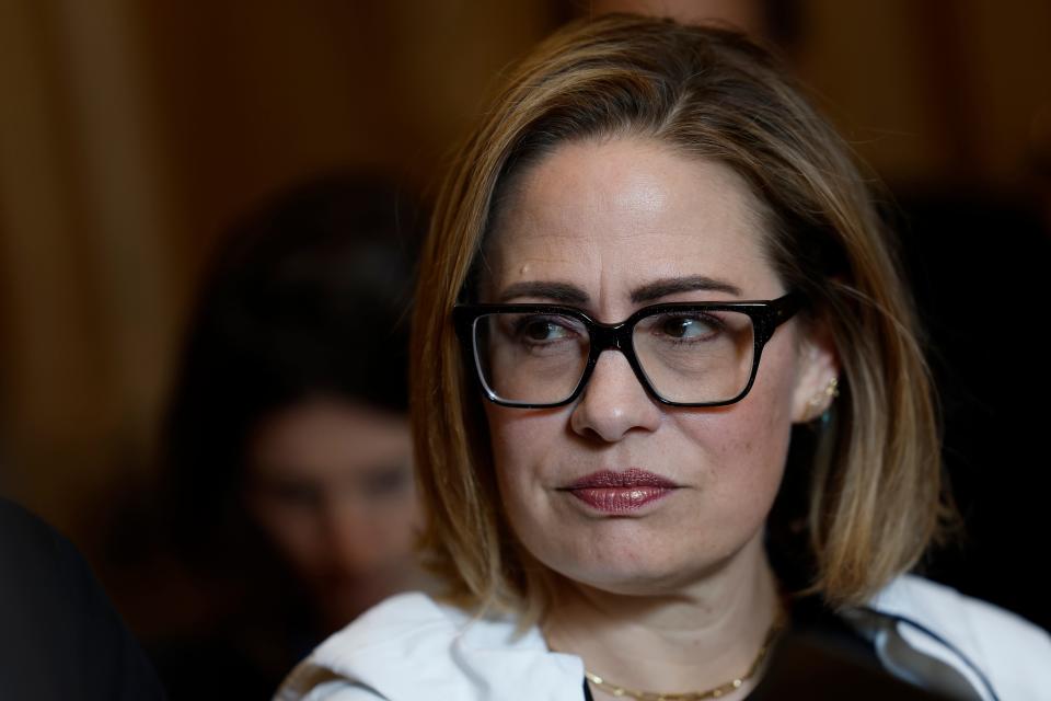 Sen. Kyrsten Sinema, I-Ariz., speaks alongside Sen. Chris Murphy, D-Conn., with reporters in the U.S. Capitol Building on Dec. 20, 2023, in Washington, D.C.