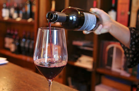 A sommelier pours a glass of red wine in Nipozzano, Italy, September 21, 2017. Picture taken September 21, 2017. REUTERS/Isla Binnie