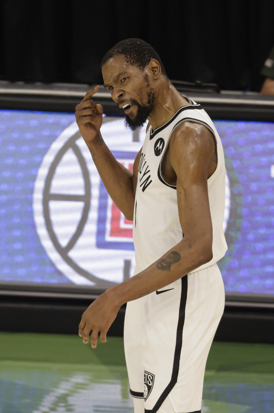 Brooklyn Nets' Kevin Durant points to his head during the second half of Game 6 of a second-round NBA basketball playoff series against the Milwaukee Bucks, Thursday, June 17, 2021, in Milwaukee. (AP Photo/Jeffrey Phelps)