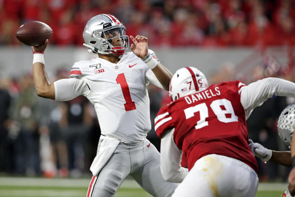 Ohio State quarterback Justin Fields (1) throws a pass as Nebraska defensive lineman Darrion Daniels (79) defends during the first half of an NCAA college football game in Lincoln, Neb., Saturday, Sept. 28, 2019. (AP Photo/Nati Harnik)