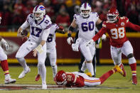 Buffalo Bills quarterback Josh Allen (17) runs from Kansas City Chiefs safety Juan Thornhill (22) during the first half of an NFL divisional round playoff football game, Sunday, Jan. 23, 2022, in Kansas City, Mo. (AP Photo/Charlie Riedel)