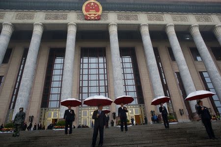 Security officers stand guard outside the Great Hall of the People before the opening of the 19th National Congress of the Communist Party of China in Beijing, China October 18, 2017. REUTERS/Thomas Peter