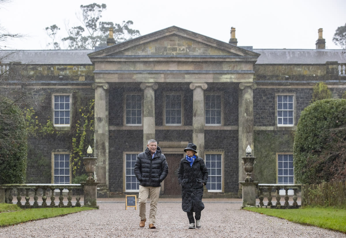 Mr McMillen speaking to counsellor Helen Laird as they walk in the gardens at Mount Stewart (Liam McBurney/PA)