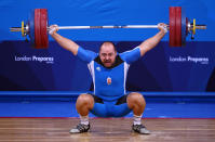 LONDON, ENGLAND - DECEMBER 11: Can Osman of Cyprus makes a lift in the Men's 105kg during the Weightlifting LOCOG Test Event for London 2012 at ExCel on December 11, 2011 in London, England. (Photo by Julian Finney/Getty Images)